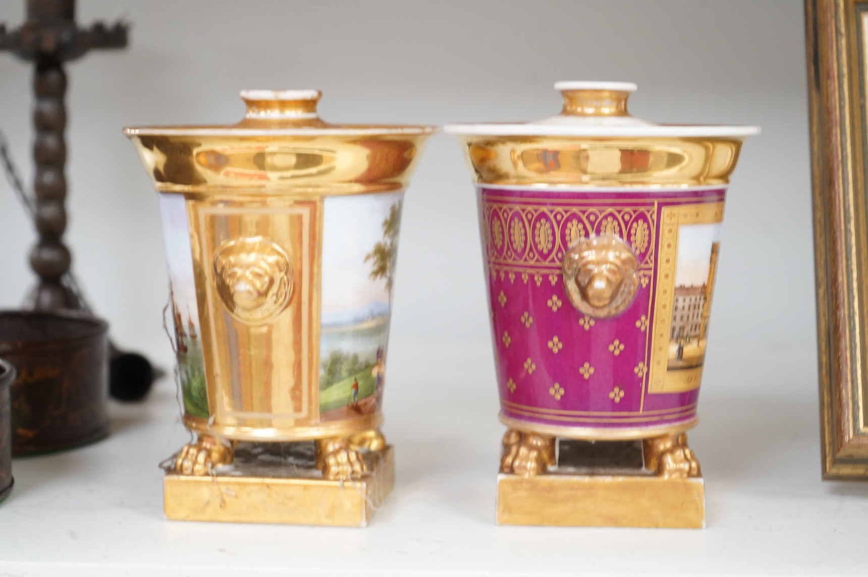 Two early 19th century Paris porcelain pastel burners and covers, decorated with continental landscapes, 15cm high